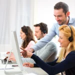 Call center supervisor reviewing AI-generated coaching insights from conversation intelligence software